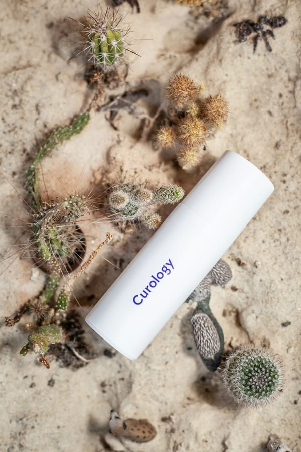 Person applying natural botanical extract to skin as part of a wellness skincare routine